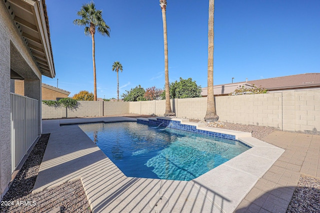 view of pool featuring pool water feature and a patio