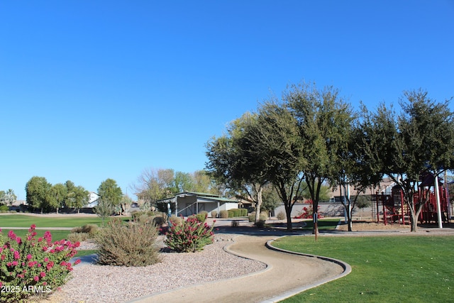 view of property's community with a lawn and a playground