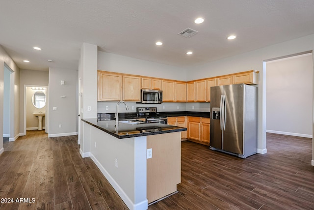 kitchen featuring dark wood-type flooring, sink, light brown cabinetry, kitchen peninsula, and stainless steel appliances