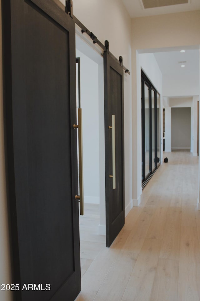 12863 E Cochise Rd, Scottsdale, AZ 85259 - corridor featuring a barn door and light wood-style flooring