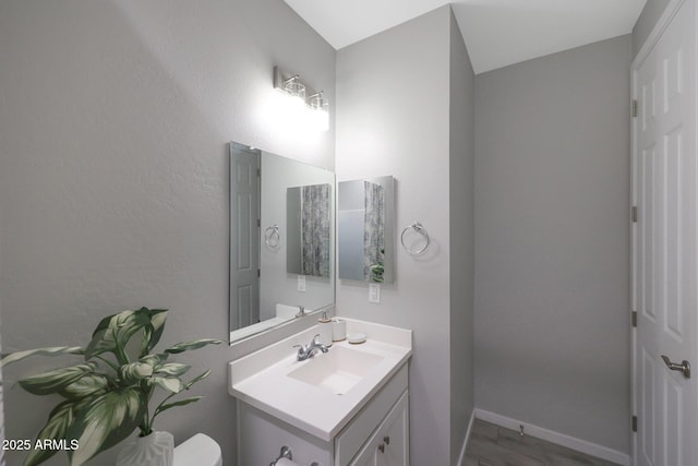 738 W Kingman Dr, Casa Grande, AZ 85122 - half bathroom with toilet, baseboards, and vanity