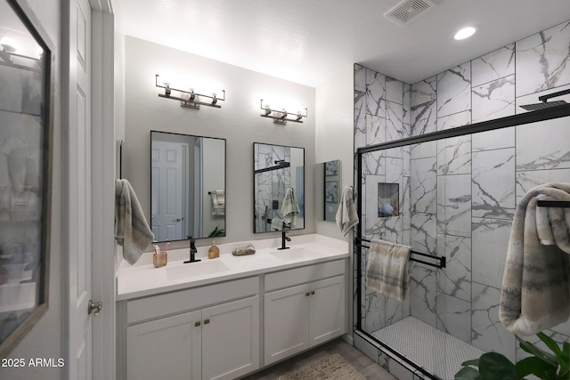 738 W Kingman Dr, Casa Grande, AZ 85122 - bathroom with visible vents, a sink, a marble finish shower, and double vanity