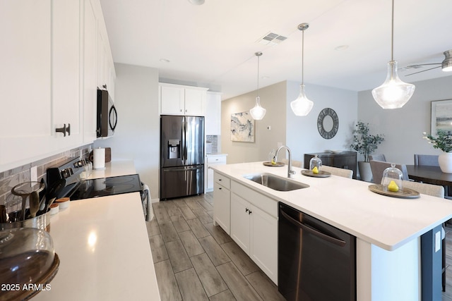 738 W Kingman Dr, Casa Grande, AZ 85122 - kitchen featuring wood finish floors, a sink, light countertops, appliances with stainless steel finishes, and decorative backsplash