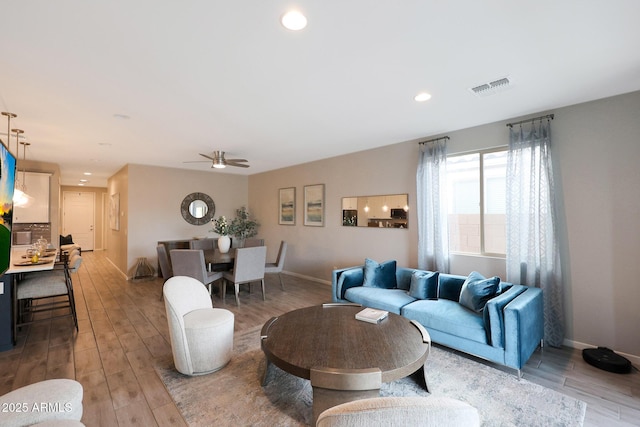 738 W Kingman Dr, Casa Grande, AZ 85122 - living area featuring light wood finished floors, baseboards, visible vents, and recessed lighting