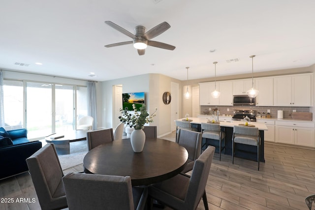 738 W Kingman Dr, Casa Grande, AZ 85122 - dining space featuring light wood-style flooring, visible vents, ceiling fan, and recessed lighting