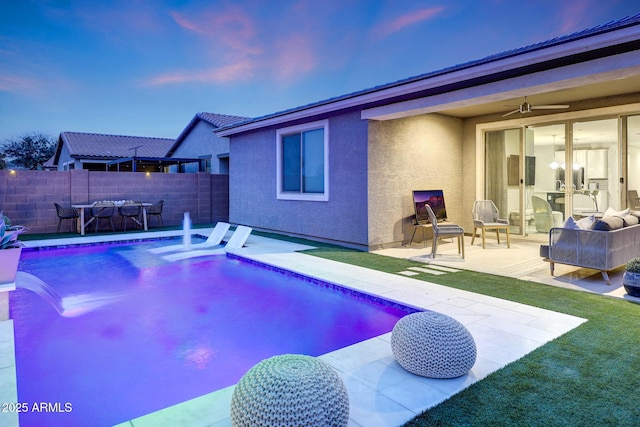 738 W Kingman Dr, Casa Grande, AZ 85122 - pool at dusk with a fenced in pool, fence, a ceiling fan, and a patio