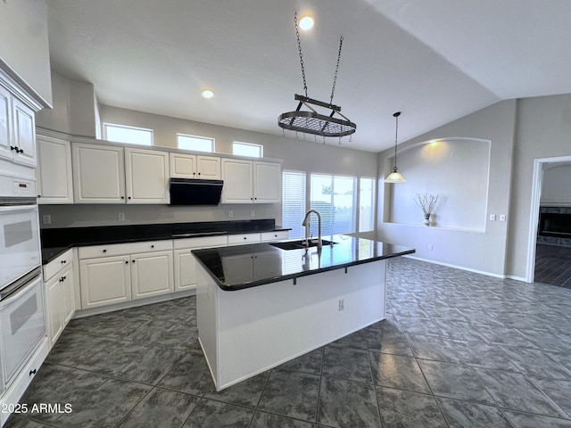 kitchen with sink, white cabinetry, double oven, pendant lighting, and black stovetop