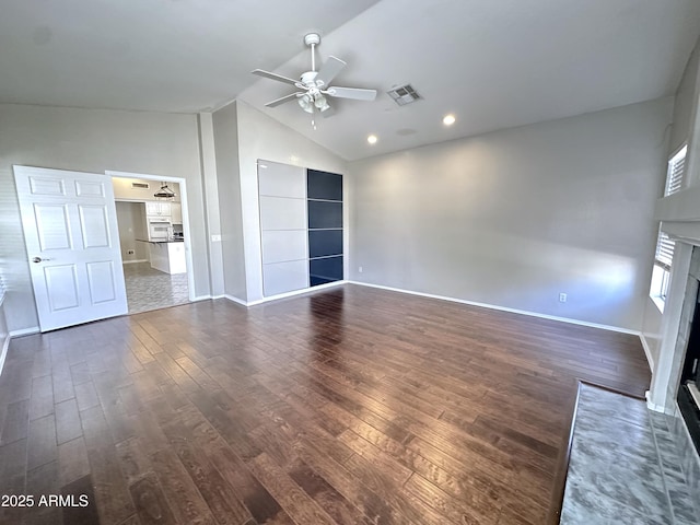 unfurnished living room featuring ceiling fan, dark hardwood / wood-style floors, and high vaulted ceiling