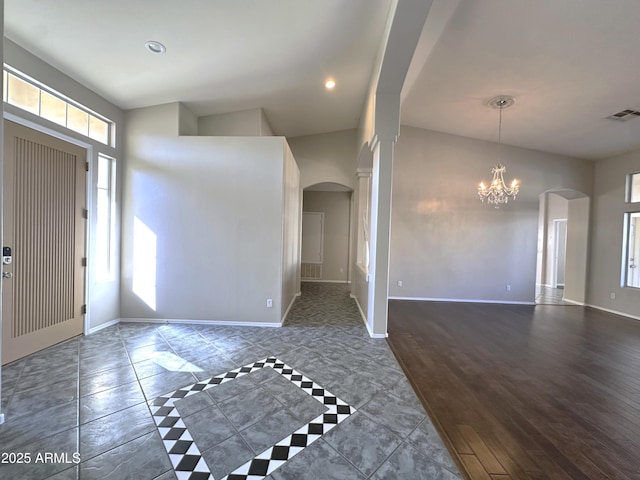 foyer entrance featuring dark hardwood / wood-style flooring and an inviting chandelier