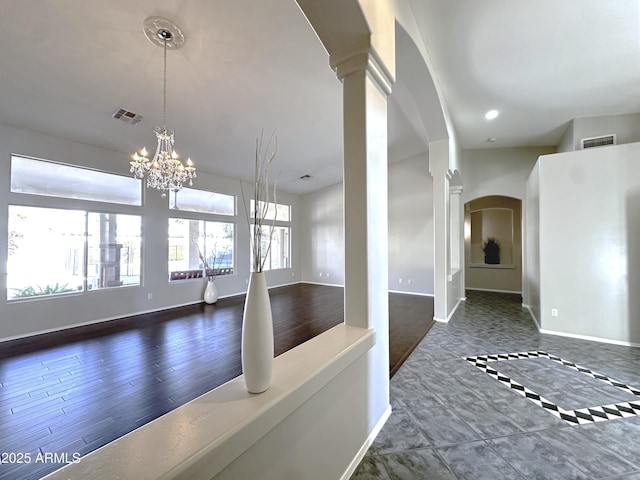 interior space with a notable chandelier and ornate columns