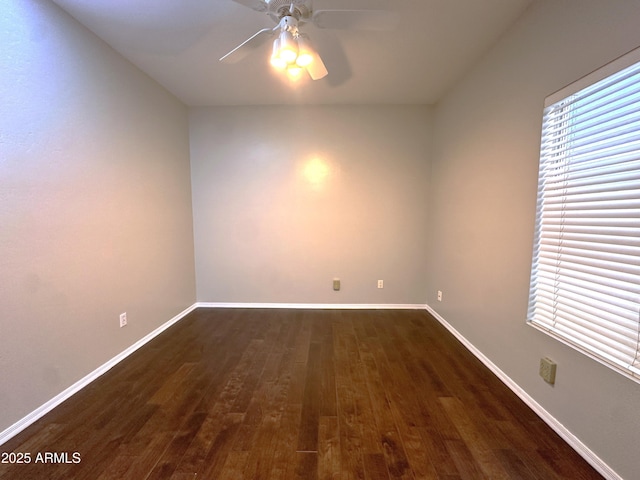 unfurnished room featuring a wealth of natural light, dark hardwood / wood-style floors, and ceiling fan