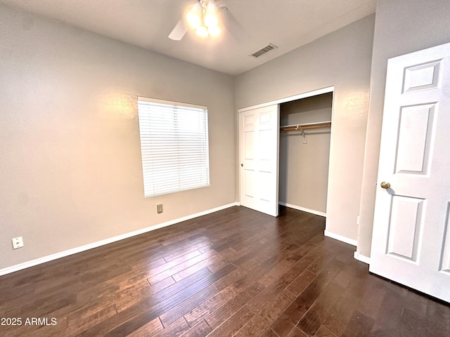 unfurnished bedroom with ceiling fan, dark hardwood / wood-style flooring, and a closet