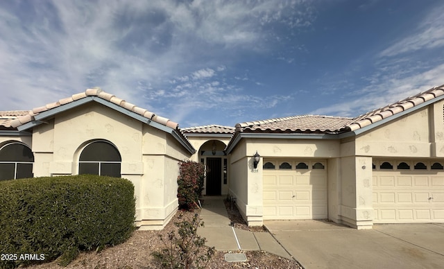 mediterranean / spanish home featuring a garage