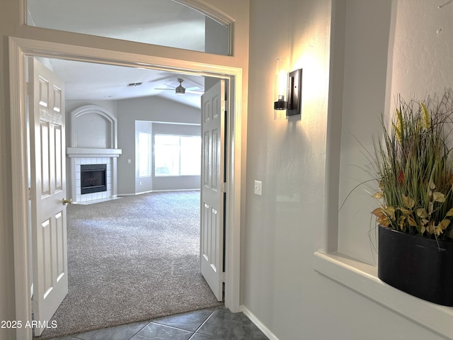 hall with vaulted ceiling and carpet