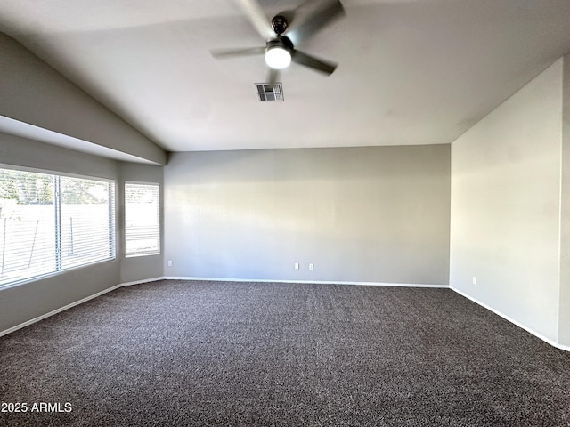 carpeted empty room with vaulted ceiling and ceiling fan