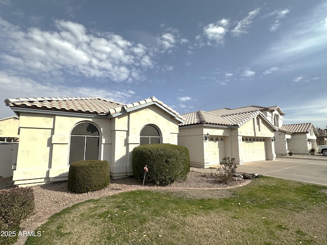 mediterranean / spanish home with a garage and a front yard