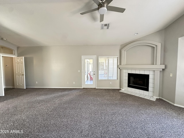 unfurnished living room featuring ceiling fan, vaulted ceiling, carpet floors, and a fireplace