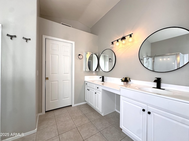 bathroom with tile patterned flooring, vanity, lofted ceiling, and a shower with door