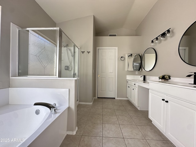 bathroom featuring vanity, vaulted ceiling, tile patterned floors, and plus walk in shower