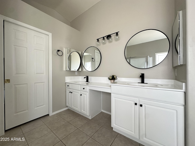 bathroom with vanity, tile patterned flooring, and vaulted ceiling