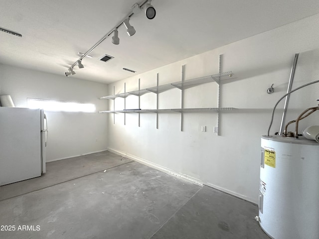 garage featuring white refrigerator and electric water heater