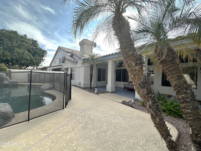 view of patio / terrace with a fenced in pool