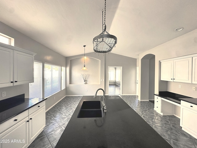 kitchen with white cabinetry, sink, and pendant lighting