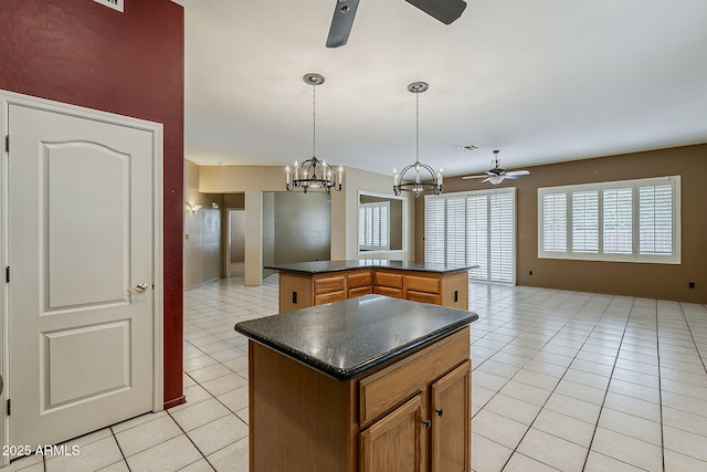 1391 W Windhaven Ave, Gilbert, AZ 85233 - kitchen featuring a ceiling fan, a center island, dark countertops, and light tile patterned flooring