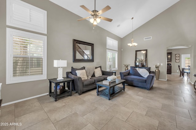 2016 S 102nd Ln, Tolleson, AZ 85353 - living area with arched walkways, high vaulted ceiling, a ceiling fan, healthy amount of natural light, and a chandelier