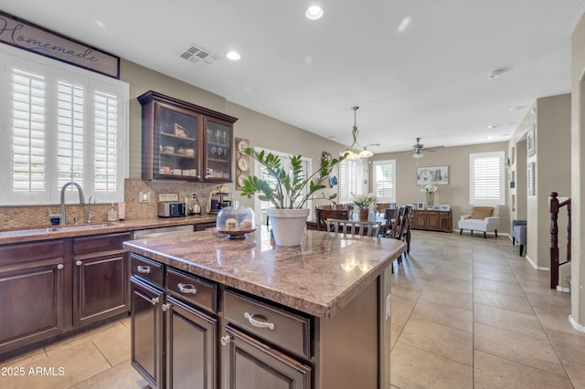 2016 S 102nd Ln, Tolleson, AZ 85353 - kitchen featuring a sink, a center island, light tile patterned flooring, open floor plan, and ceiling fan