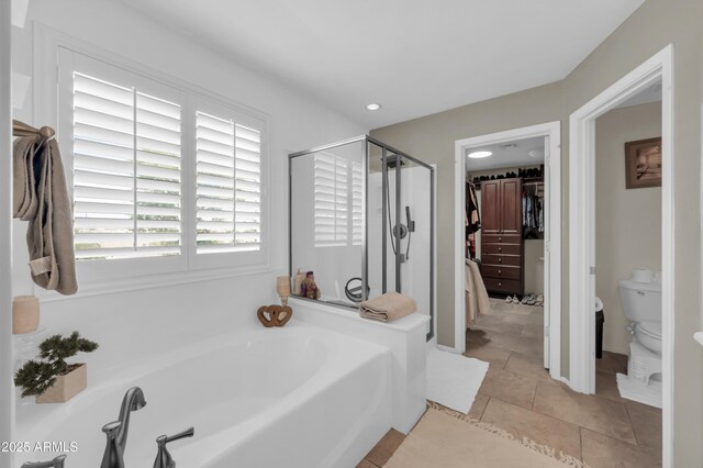 2016 S 102nd Ln, Tolleson, AZ 85353 - full bathroom with a garden tub, a walk in closet, a stall shower, toilet, and tile patterned floors