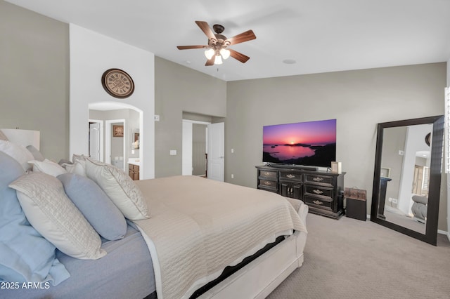 2016 S 102nd Ln, Tolleson, AZ 85353 - bedroom with vaulted ceiling, light carpet, ensuite bathroom, a ceiling fan, and arched walkways