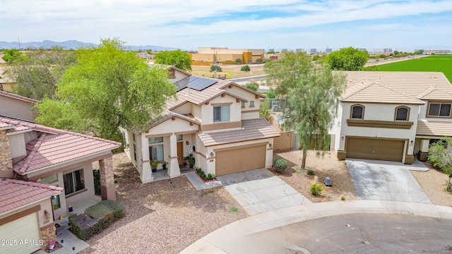 2016 S 102nd Ln, Tolleson, AZ 85353 - view of front facade with driveway, an attached garage, stucco siding, and a residential view