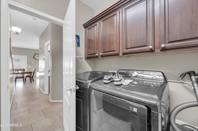 2016 S 102nd Ln, Tolleson, AZ 85353 - laundry area with cabinet space, washing machine and dryer, light tile patterned floors, and baseboards