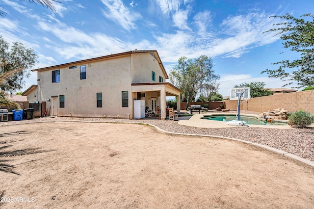 2016 S 102nd Ln, Tolleson, AZ 85353 - rear view of property featuring a fenced backyard, a patio area, and stucco siding