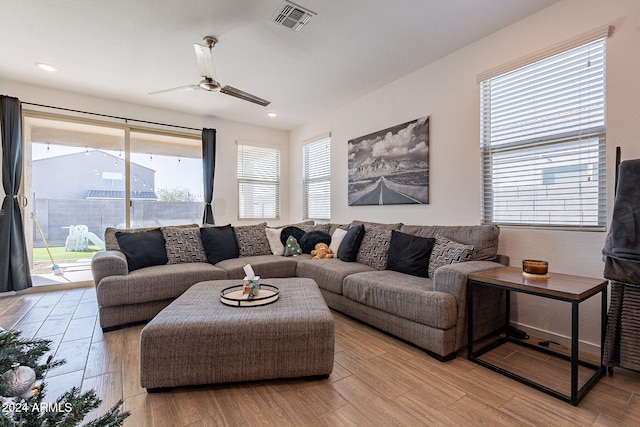 living room featuring ceiling fan and light hardwood / wood-style flooring