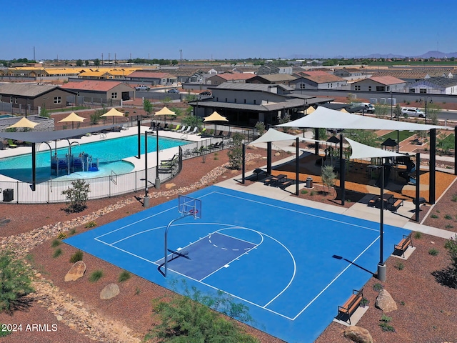 view of sport court with a community pool