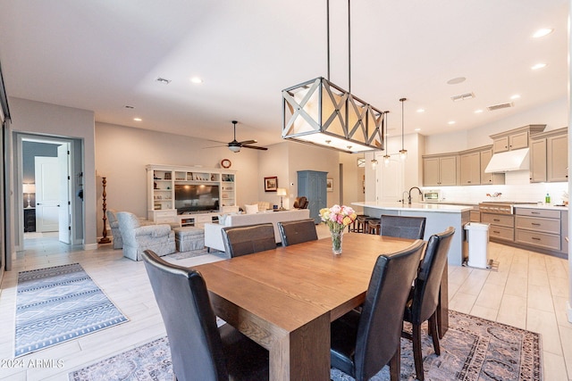 tiled dining area featuring sink and ceiling fan