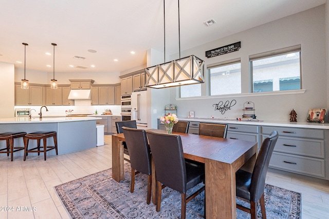 dining room with sink and light hardwood / wood-style flooring