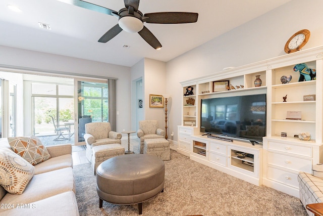 carpeted living room with ceiling fan