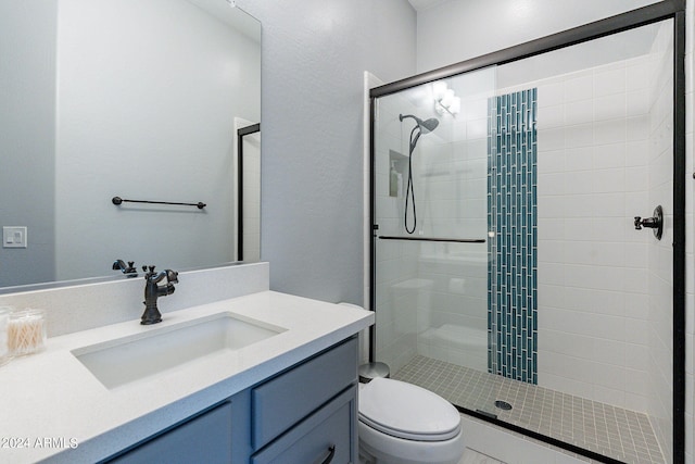 bathroom with an enclosed shower, vanity, and toilet