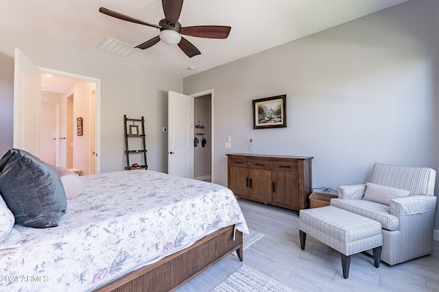 bedroom with ceiling fan and light hardwood / wood-style flooring