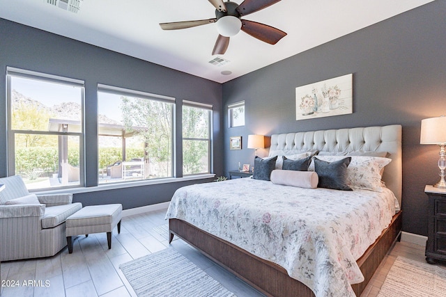 bedroom with wood-type flooring and ceiling fan