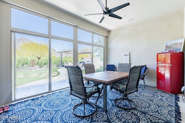 dining space with carpet flooring, plenty of natural light, and ceiling fan