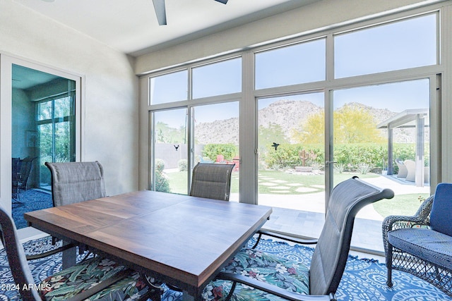 dining room featuring ceiling fan and a mountain view