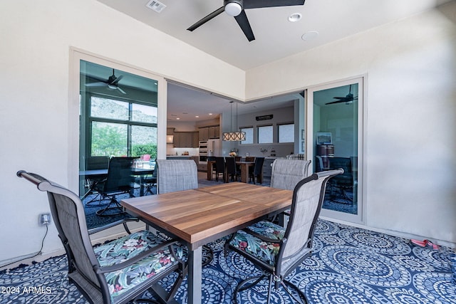 dining room with carpet and ceiling fan