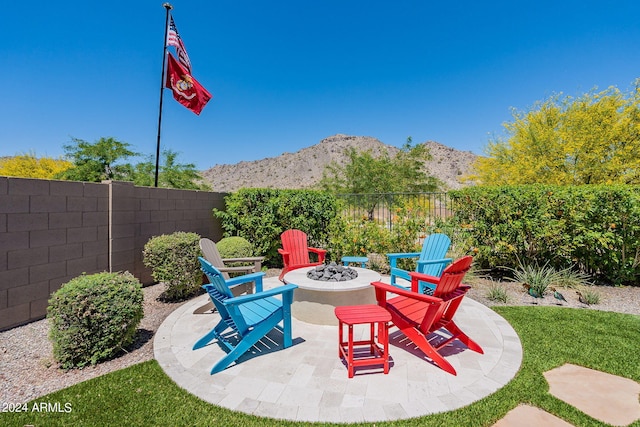 view of patio / terrace with a mountain view and an outdoor fire pit