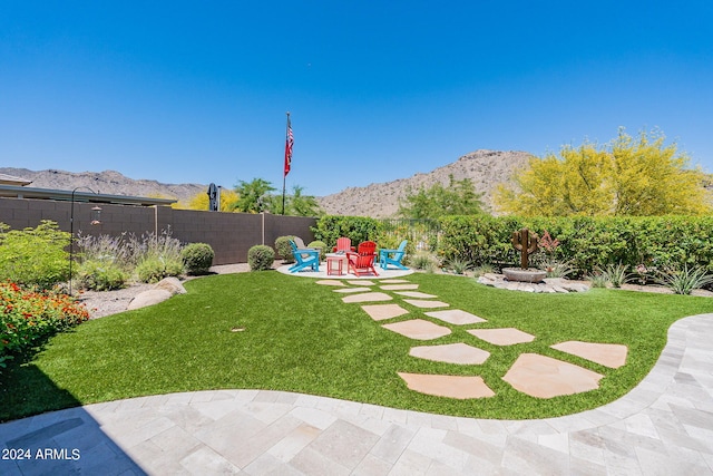 view of yard featuring a patio and a mountain view