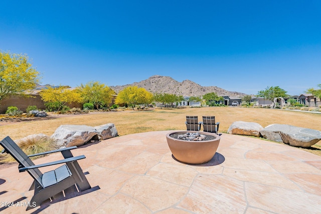 view of terrace featuring a mountain view and a fire pit