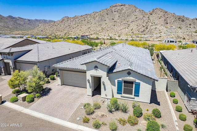 view of front of house featuring a garage and a mountain view